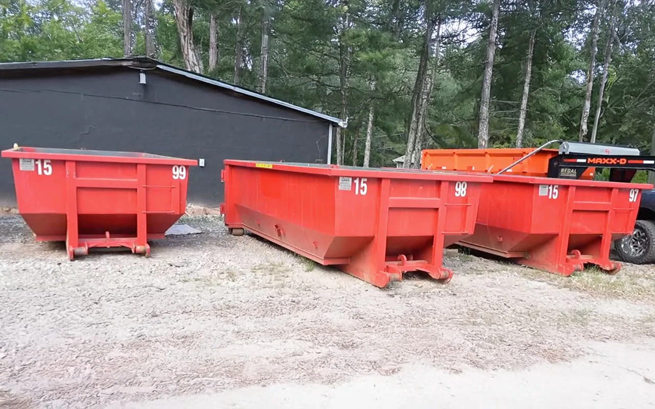 Row of red 15-yard roll-off dumpsters for rent in Senoia, GA - Haggai Dump and Haul